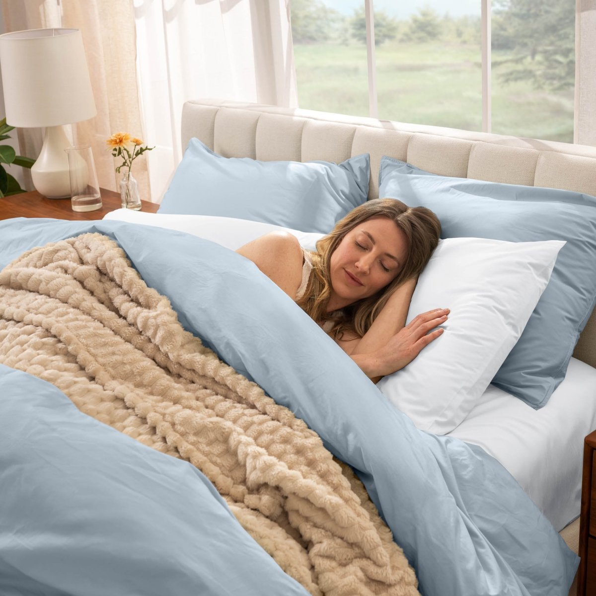Woman sleeping in a bed with percale bedding