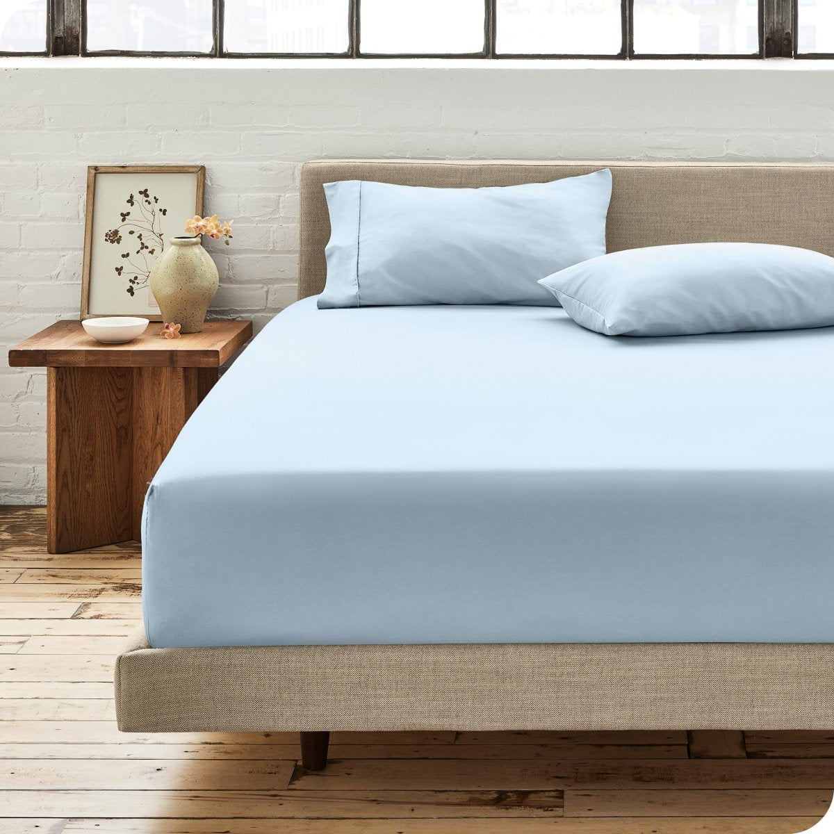 Modern bedroom with bed showing percale fitted sheet