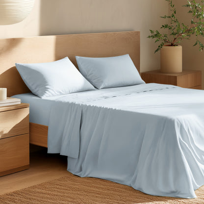 Bed with percale bedding and wooden headboard in a bedroom setting