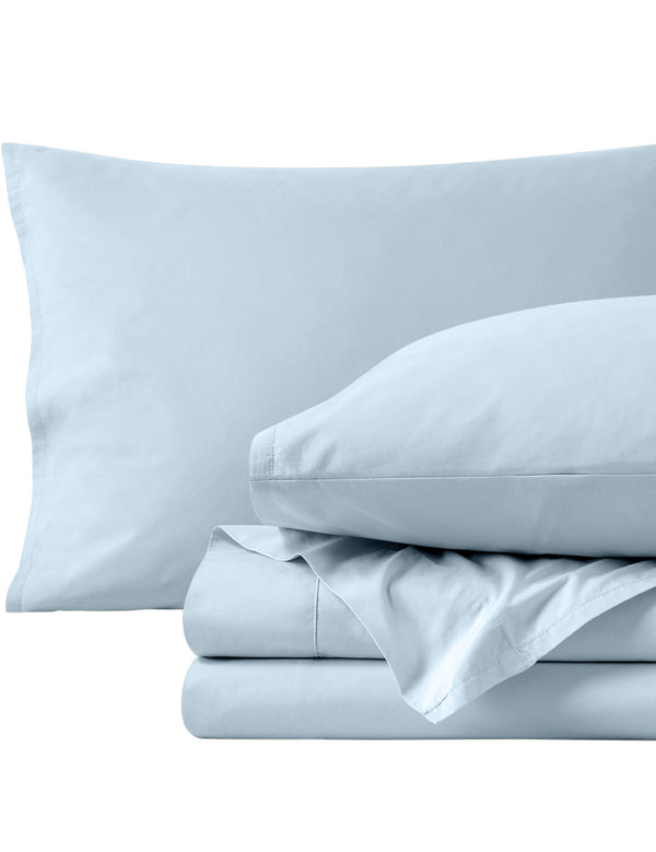 Percale sheets folded and matching pillowcases with pillows in them