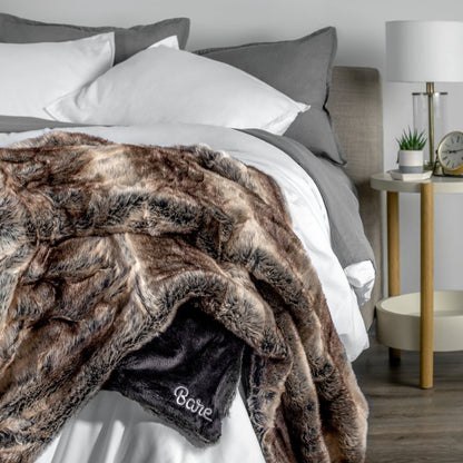 Blanket with 'Bare' branding on a bed in a bedroom setting