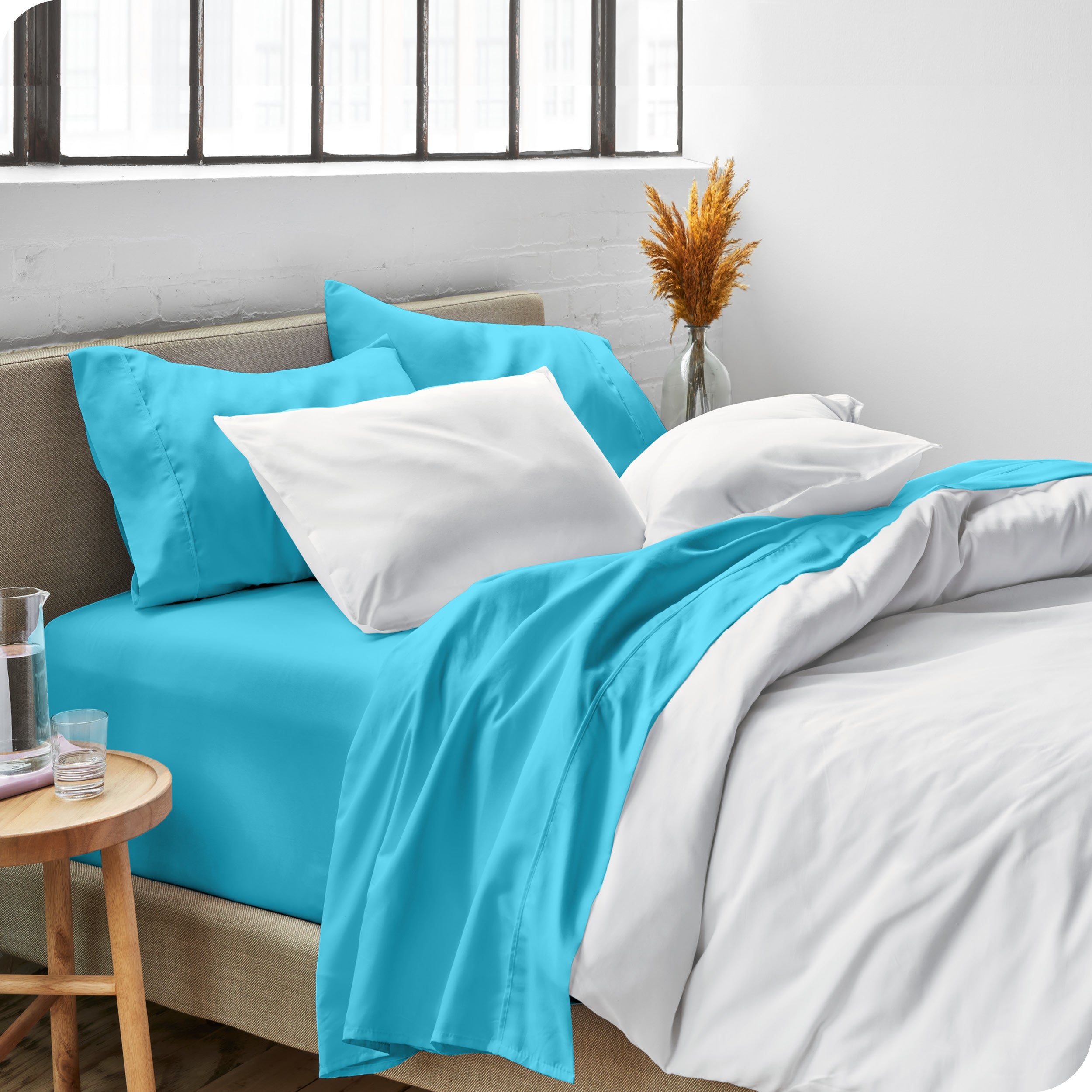 Sheets and a duvet cover on a bed in a bright bedroom