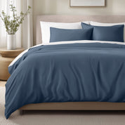 Bed with sateen bedding and pillows in a bedroom setting