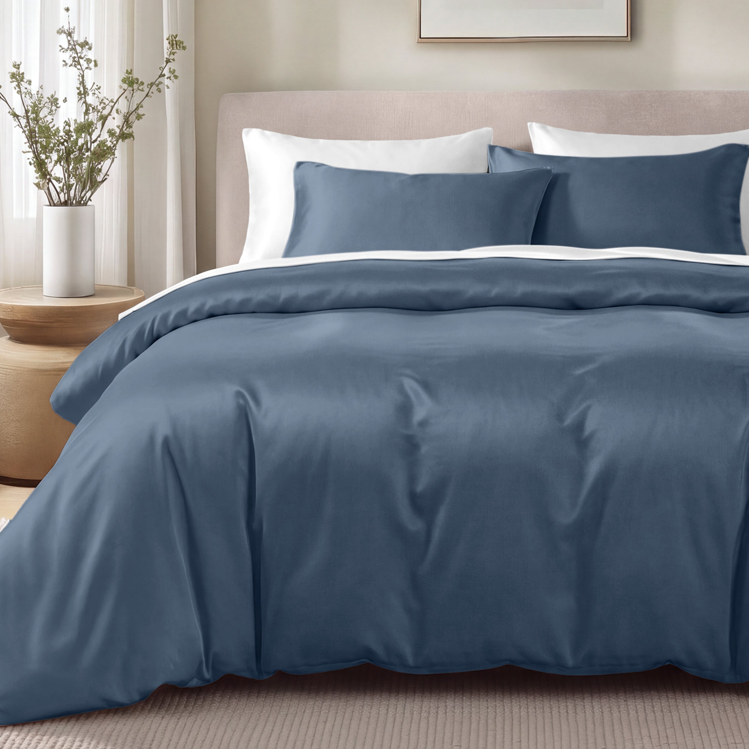 Bed with sateen bedding and pillows in a bedroom setting
