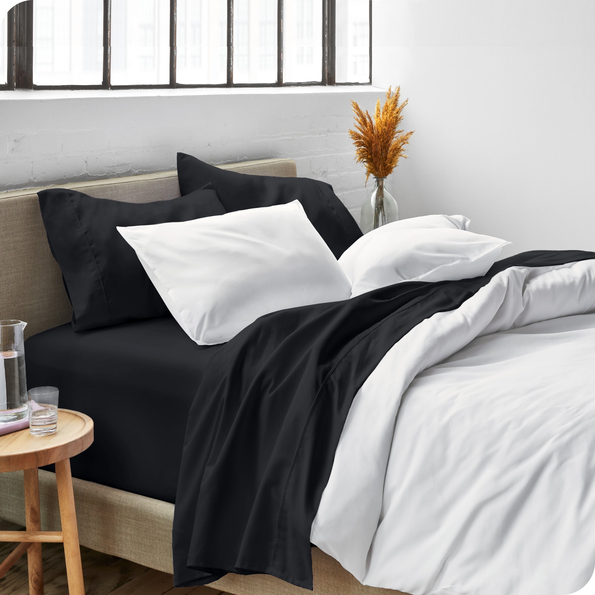 Sheets and a duvet cover on a bed in a bright bedroom