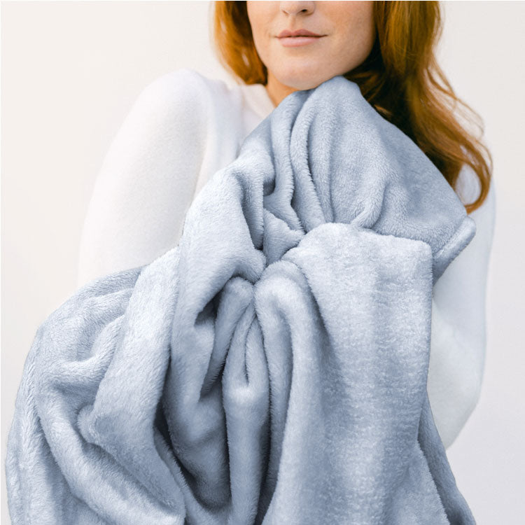 woman hugging a light blue blanket