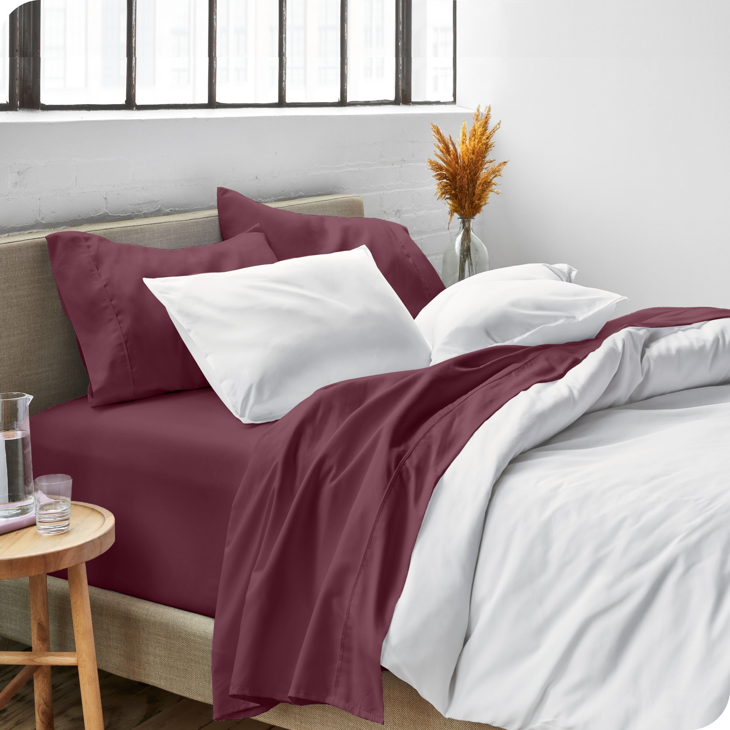 Sheets and a duvet cover on a bed in a bright bedroom