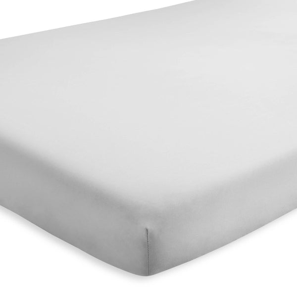 A crib mattress with a fitted sheet on it