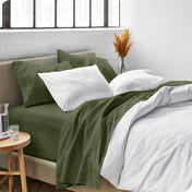 Sheets and a duvet cover on a bed in a bright bedroom