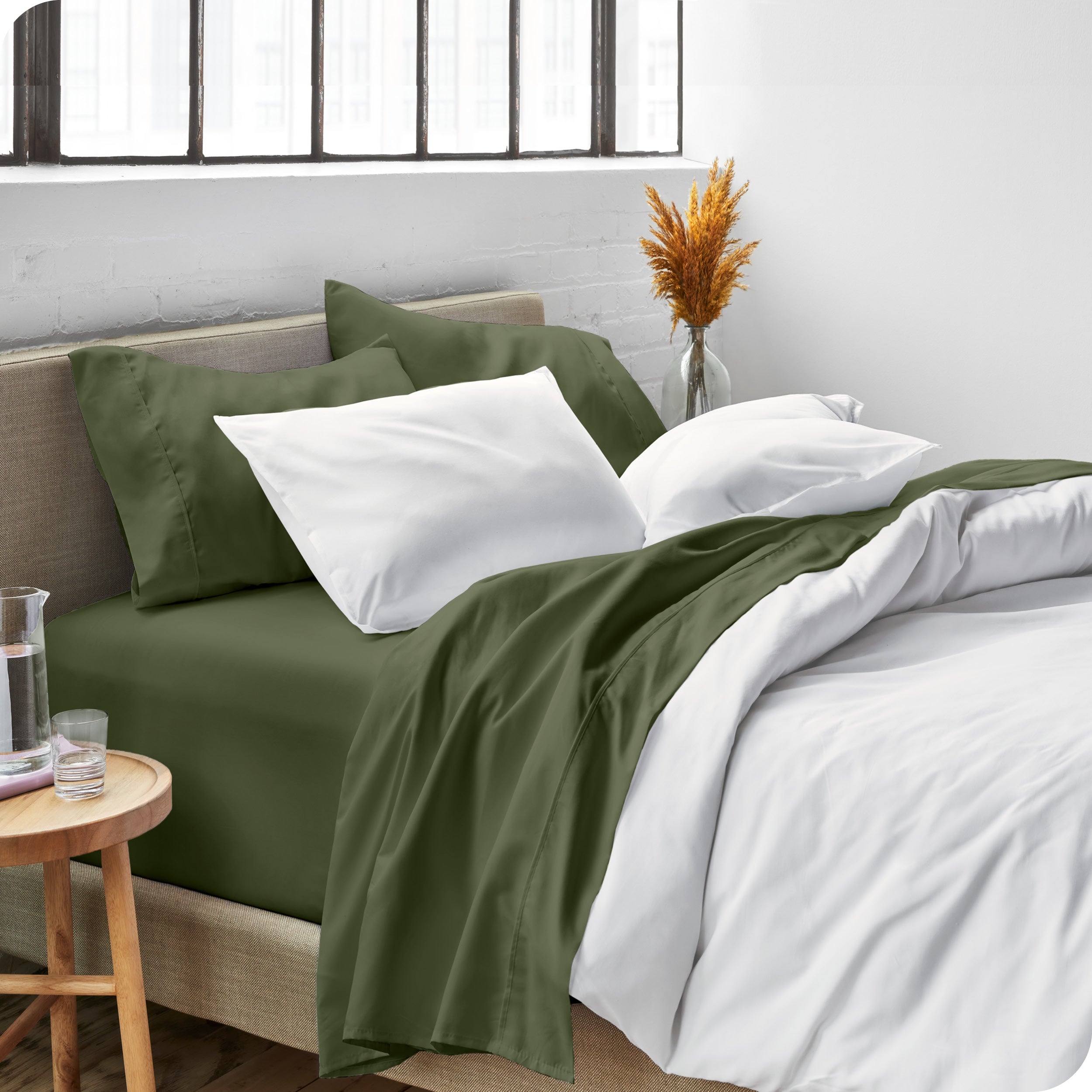 Sheets and a duvet cover on a bed in a bright bedroom