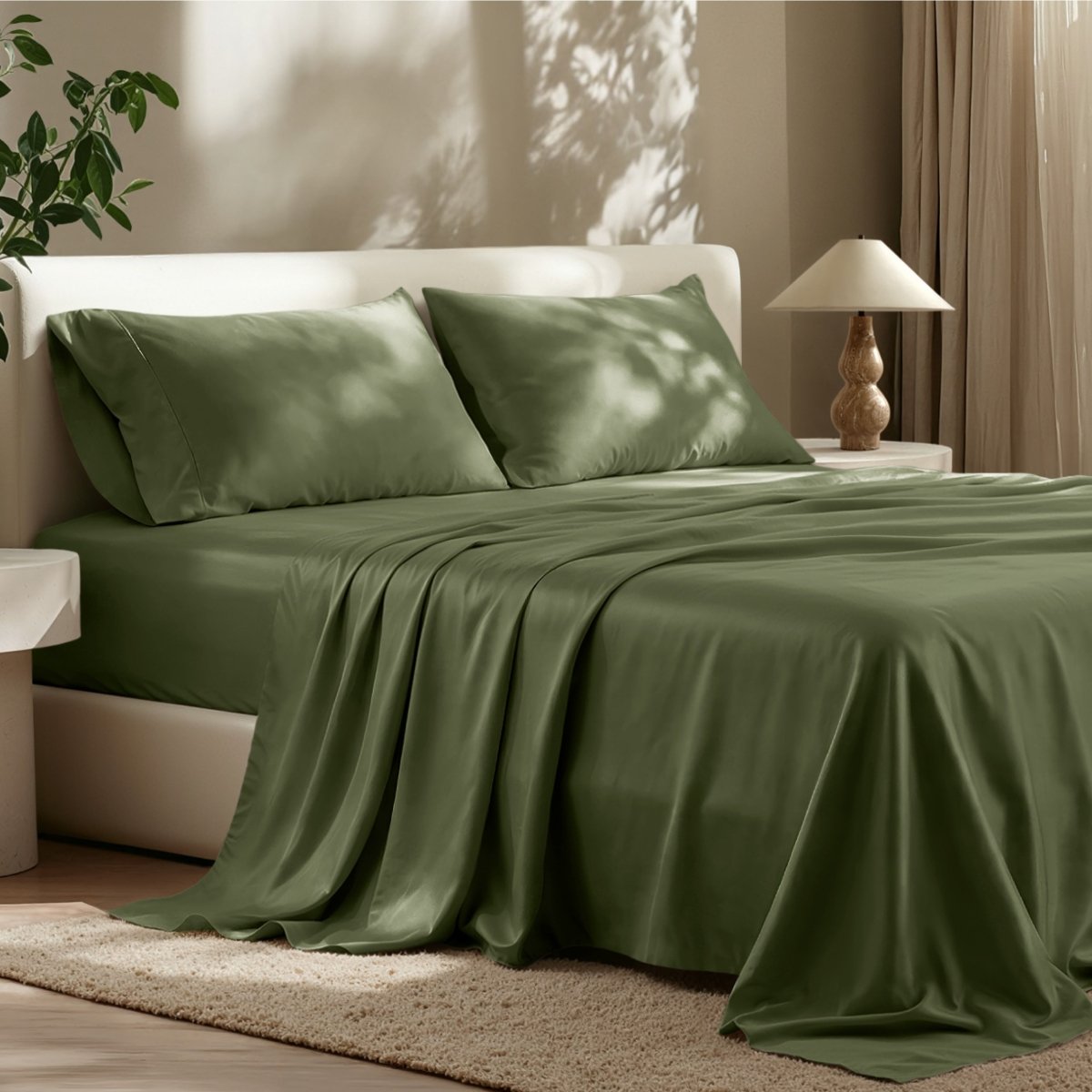 Sheet set on a bed in a bedroom with a lamp and plant.