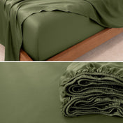Fitted sheet on a bed and folded on a surface