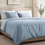 Bed with organic cotton sateen bedding in a bedroom setting.