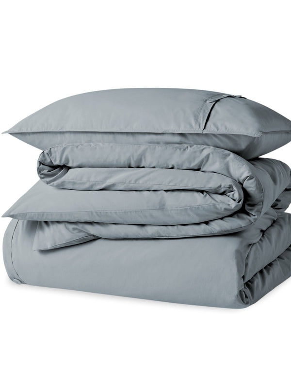 A percale duvet set folded and stacked