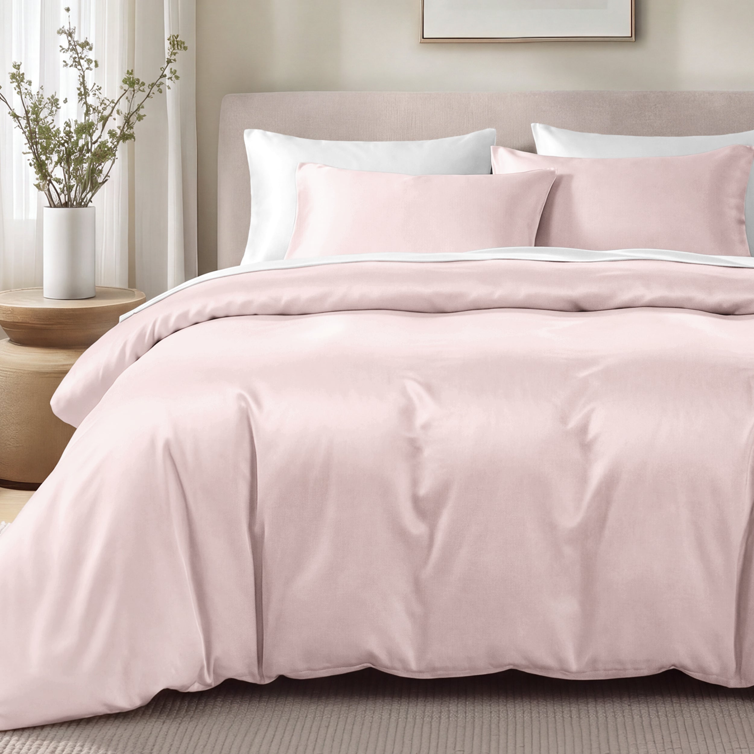 Bed with sateen bedding and pillows in a bedroom setting