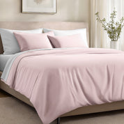 Bed with organic cotton sateen bedding in a bedroom setting.