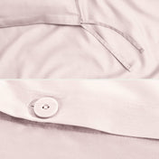 Close-up of a sateen duvet cover with a button and ties