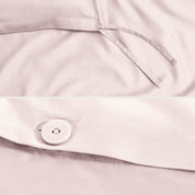 Close-up of a sateen duvet cover with a button and ties