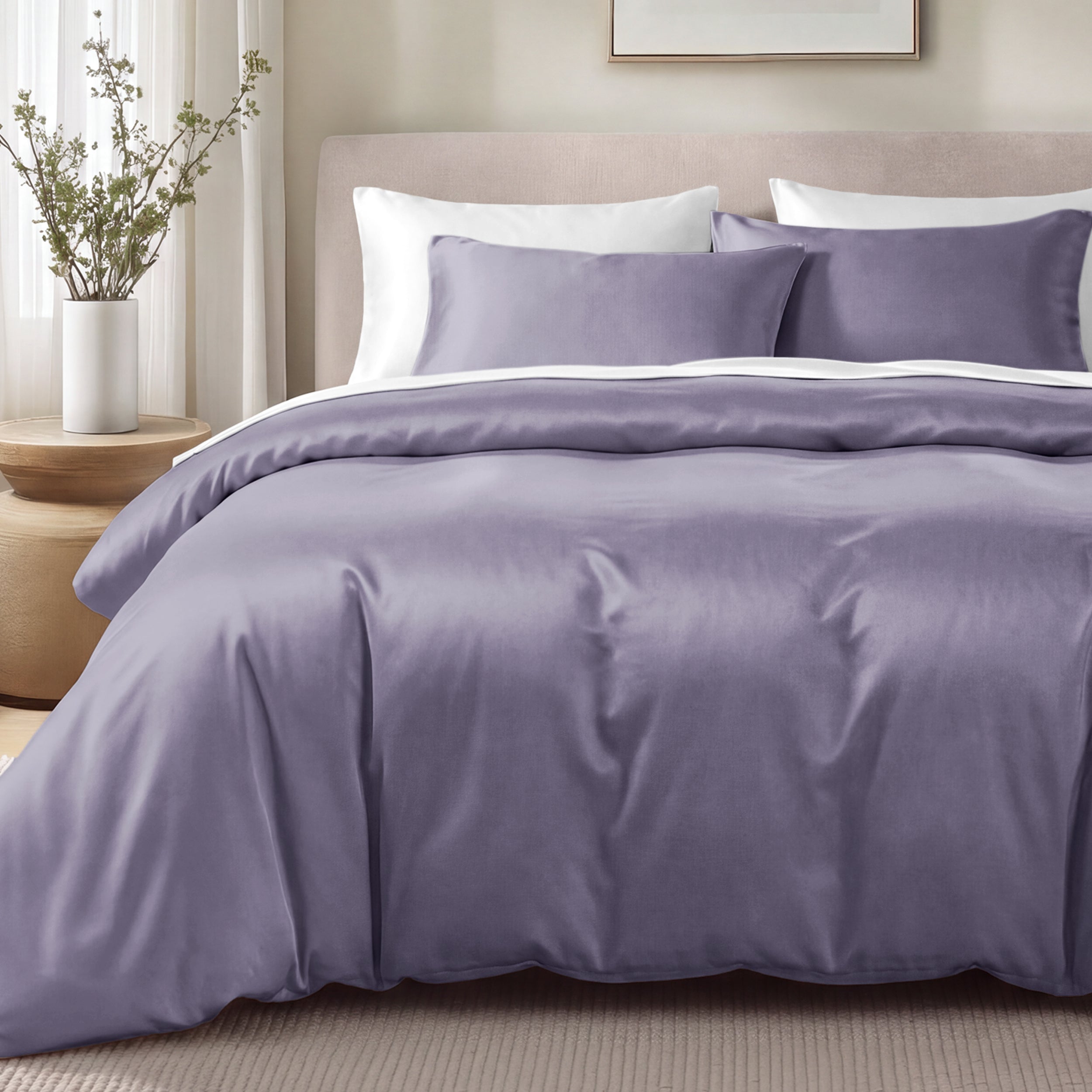 Bed with sateen bedding and pillows in a bedroom setting