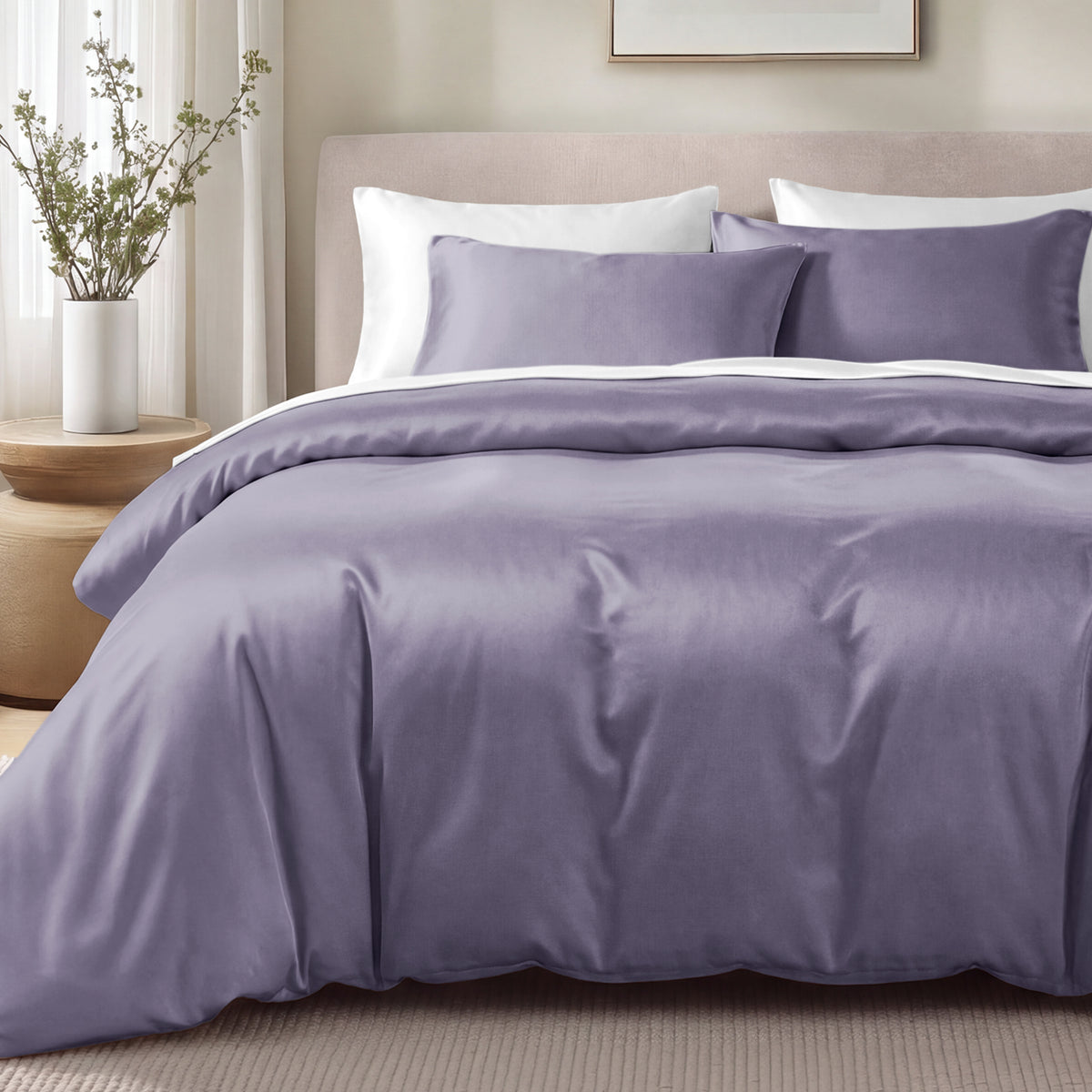 Bed with sateen bedding and pillows in a bedroom setting