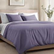 Bed with organic cotton sateen bedding in a bedroom setting.
