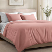 Bed with organic cotton sateen bedding in a bedroom setting.