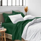 Sheets and a duvet cover on a bed in a bright bedroom