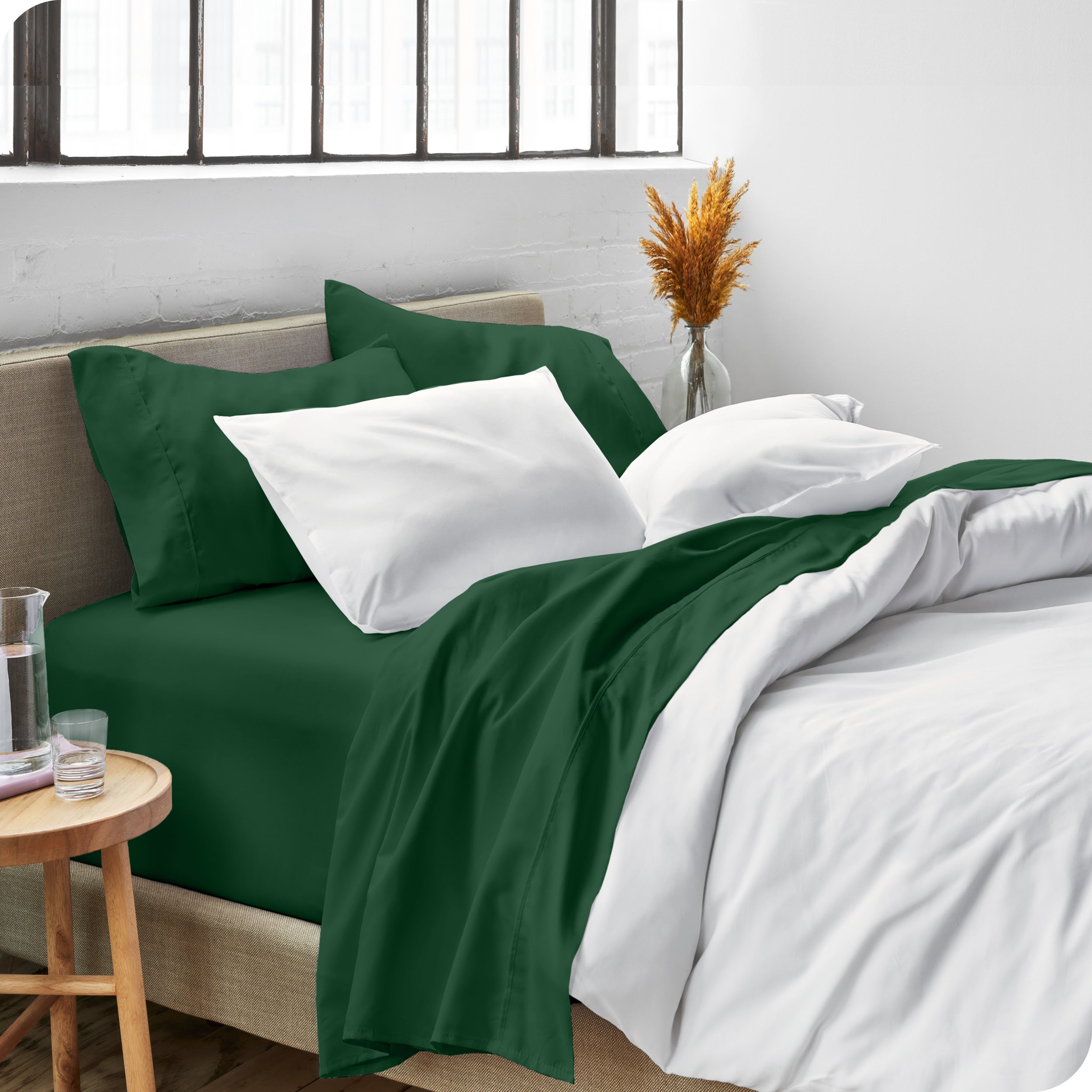 Sheets and a duvet cover on a bed in a bright bedroom