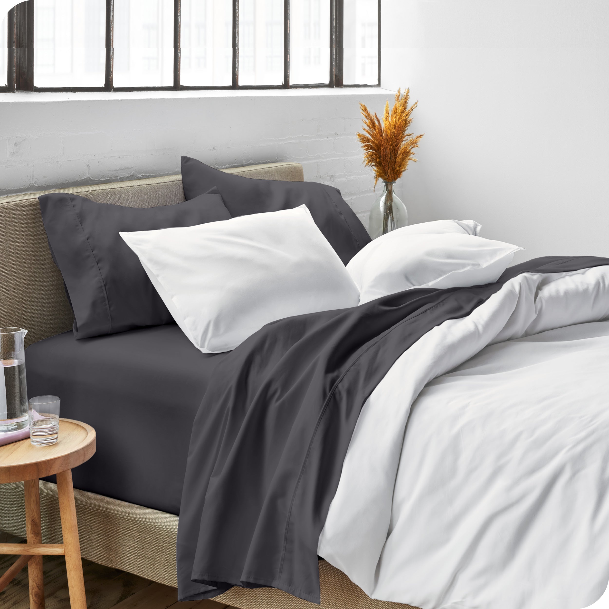 Sheets and a duvet cover on a bed in a bright bedroom