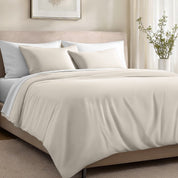 Bed with organic cotton sateen bedding in a bedroom setting.