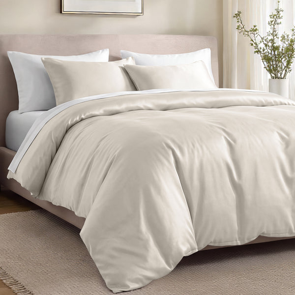 Bed with organic cotton sateen bedding in a bedroom setting.