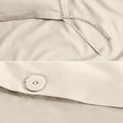 Close-up of a sateen duvet cover with a button and ties