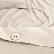 Close-up of a sateen duvet cover with a button and ties