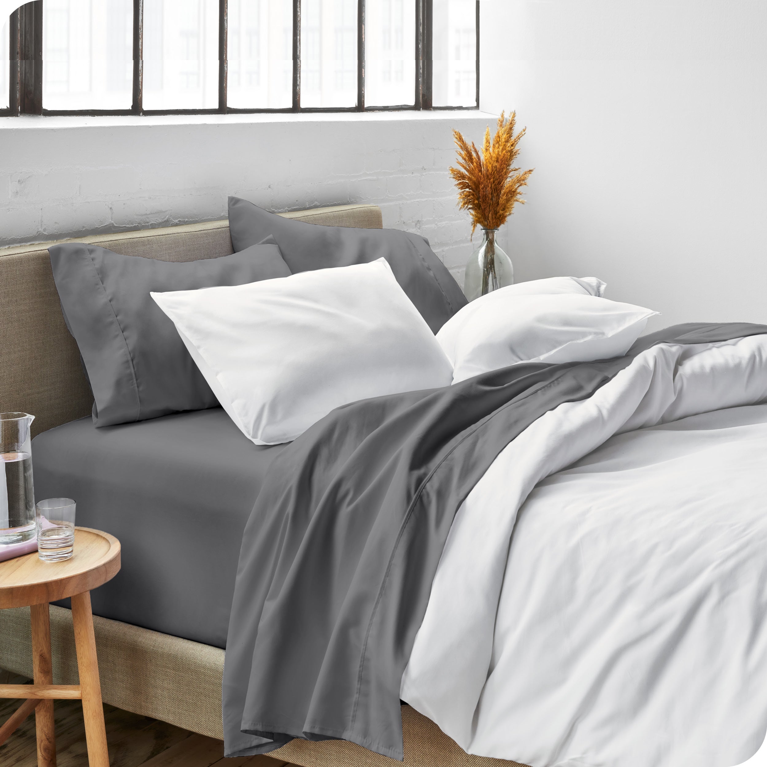 Sheets and a duvet cover on a bed in a bright bedroom