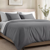 Bed with organic cotton sateen bedding in a bedroom setting.