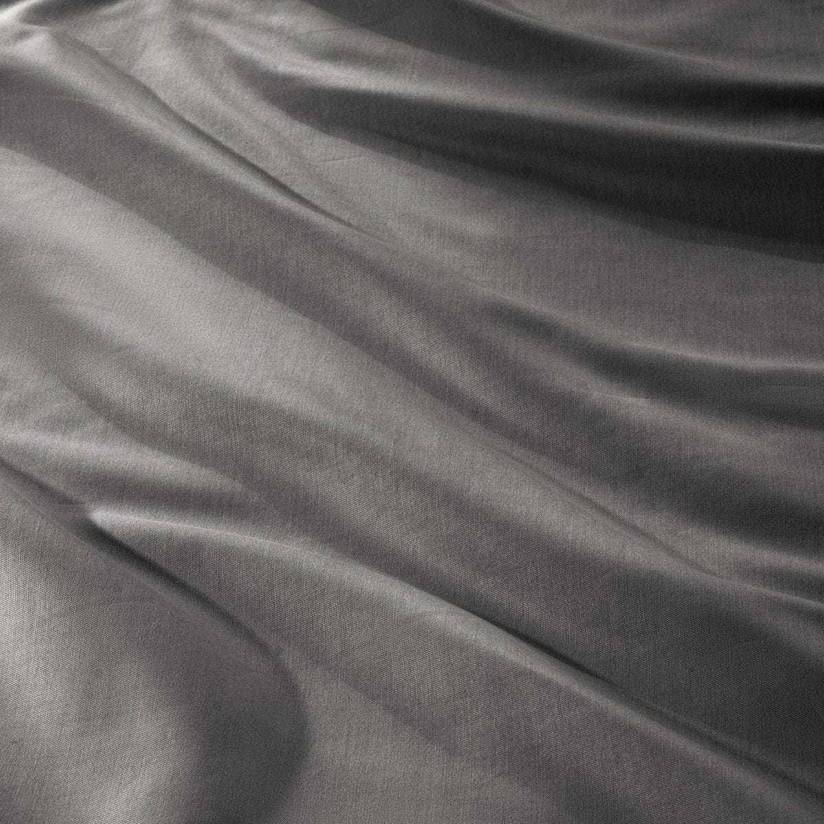 Close-up of a sateen duvet cover with a button and ties