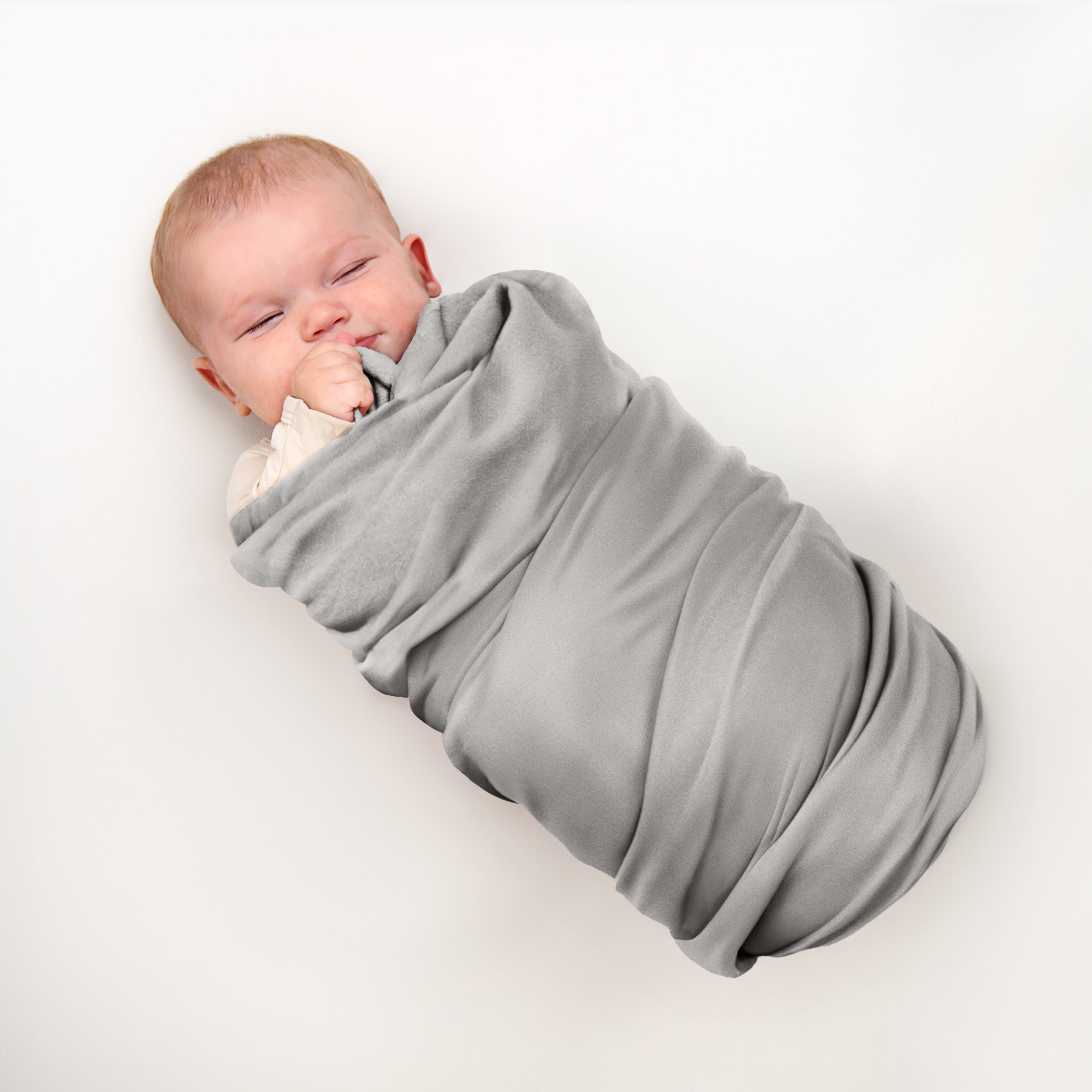 Baby wrapped in flannel receiving blanket light grey