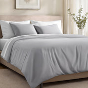 Bed with organic cotton sateen bedding in a bedroom setting.