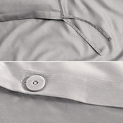 Close-up of a sateen duvet cover with a button and ties