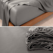 Fitted sheet on a bed and folded on a surface