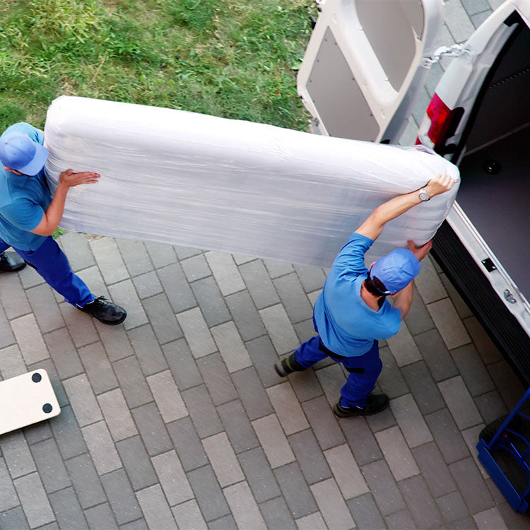 Two men loading up a mattress