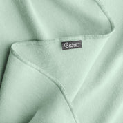 Up close image flannel receiving blanket showing tag