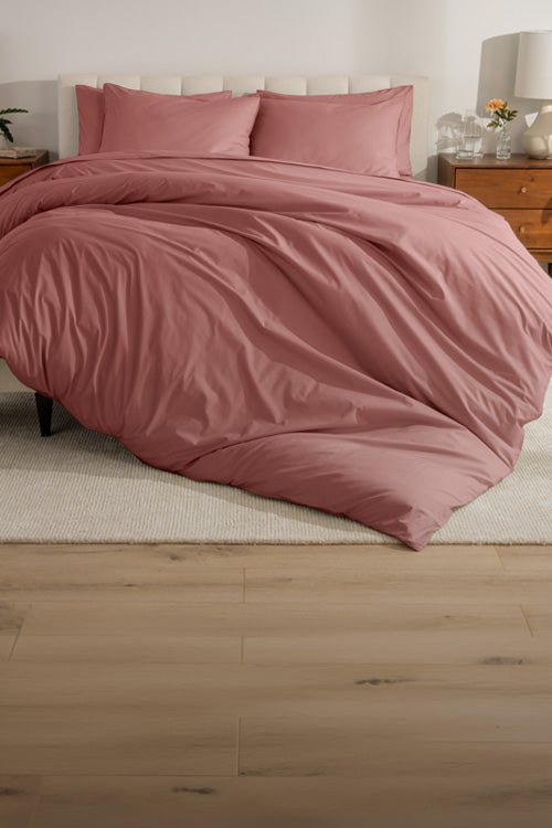 Rose colored percale bedding in a clean bedroom