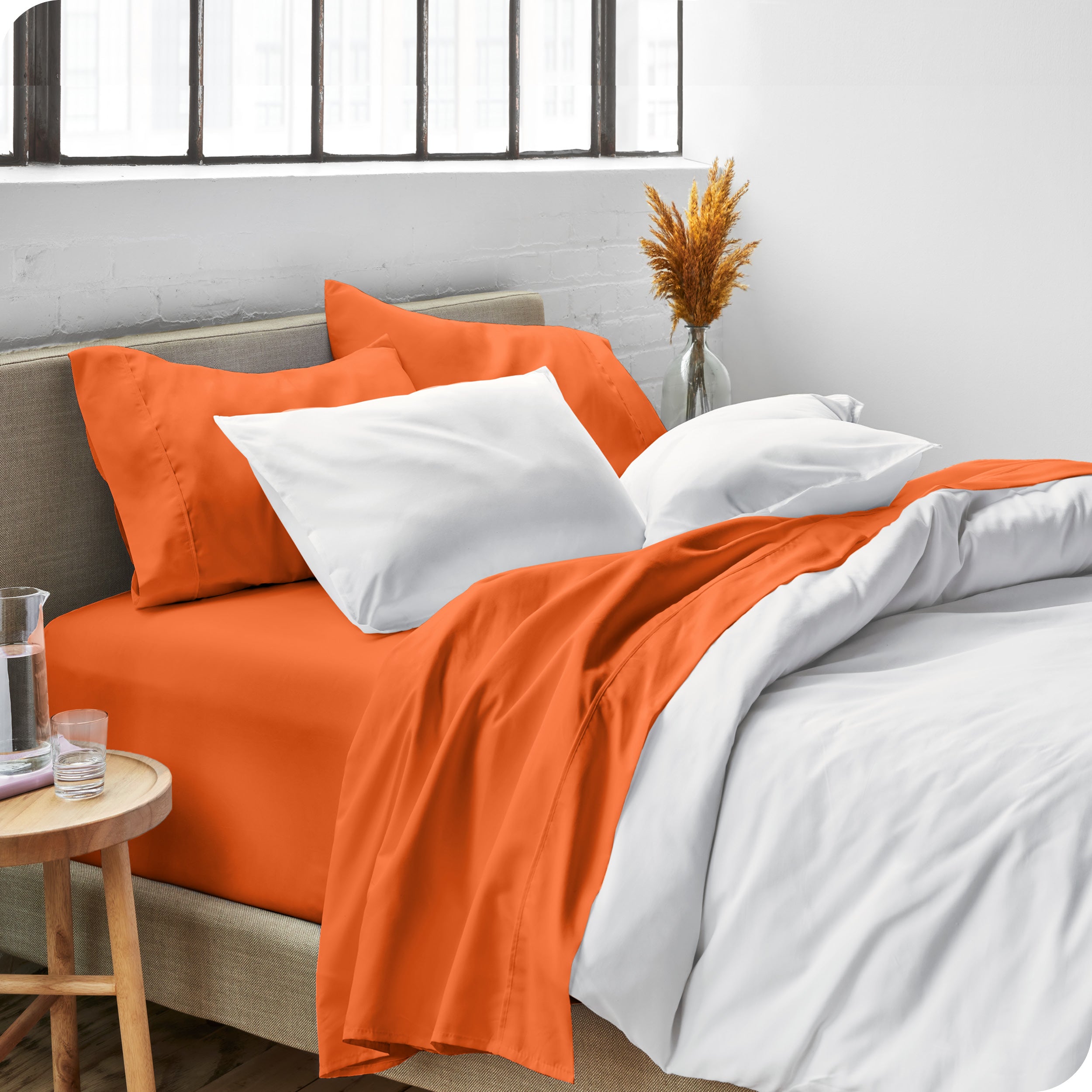 Sheets and a duvet cover on a bed in a bright bedroom