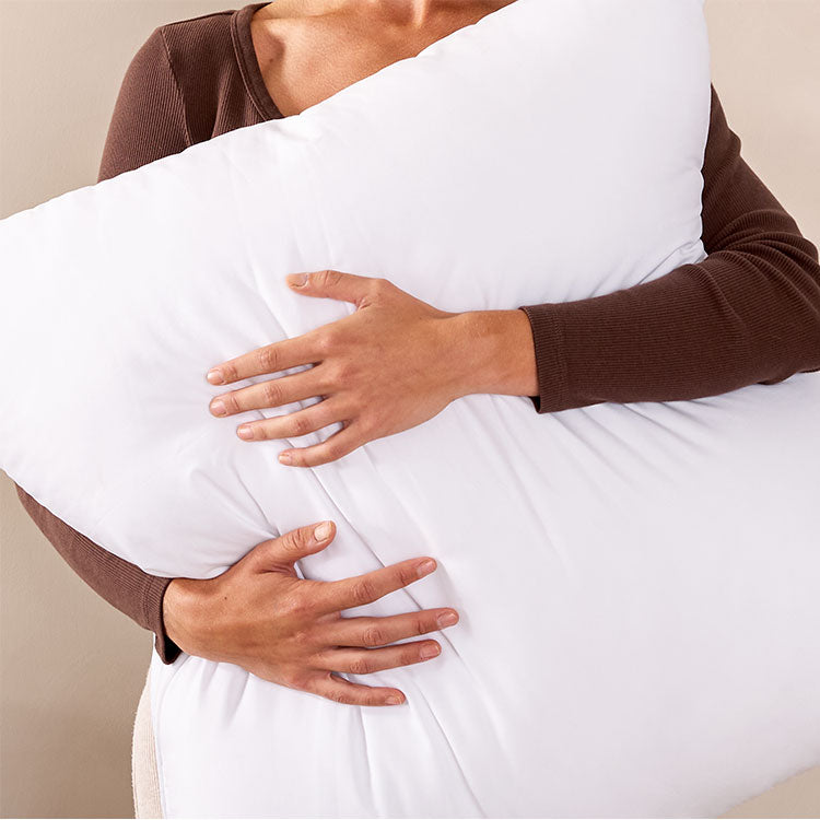 Woman Squeezing a white pillow
