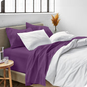 Sheets and a duvet cover on a bed in a bright bedroom