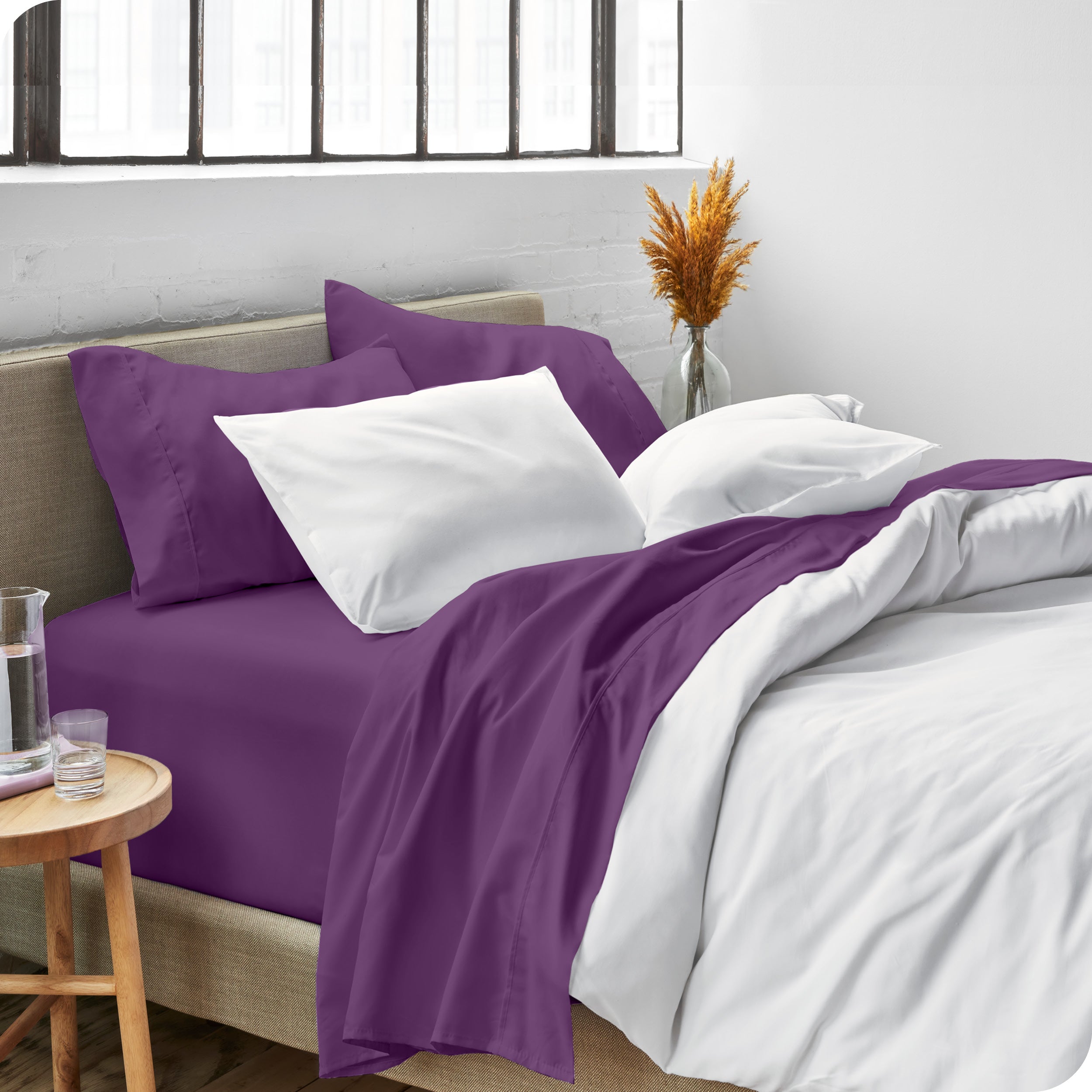 Sheets and a duvet cover on a bed in a bright bedroom