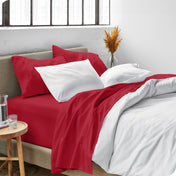 Sheets and a duvet cover on a bed in a bright bedroom