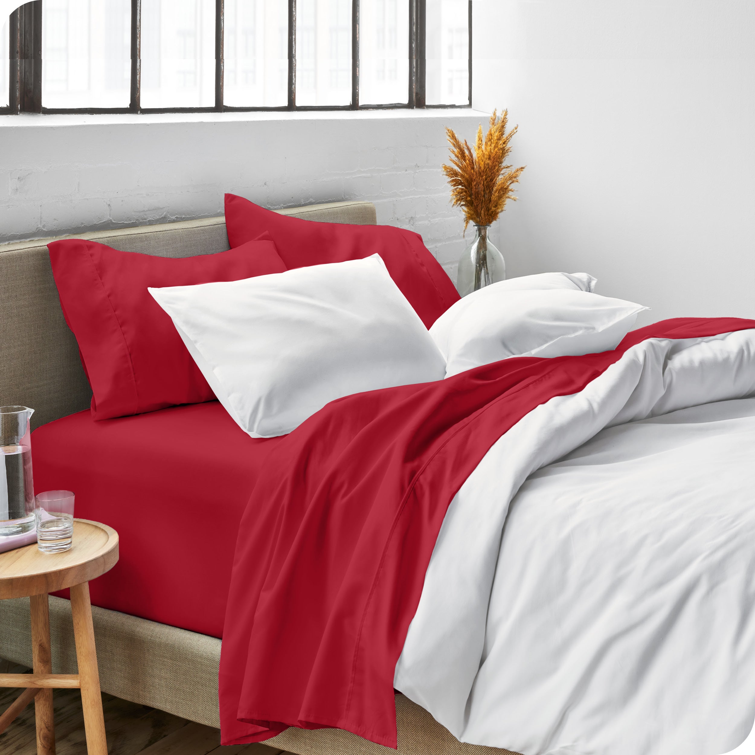 Sheets and a duvet cover on a bed in a bright bedroom