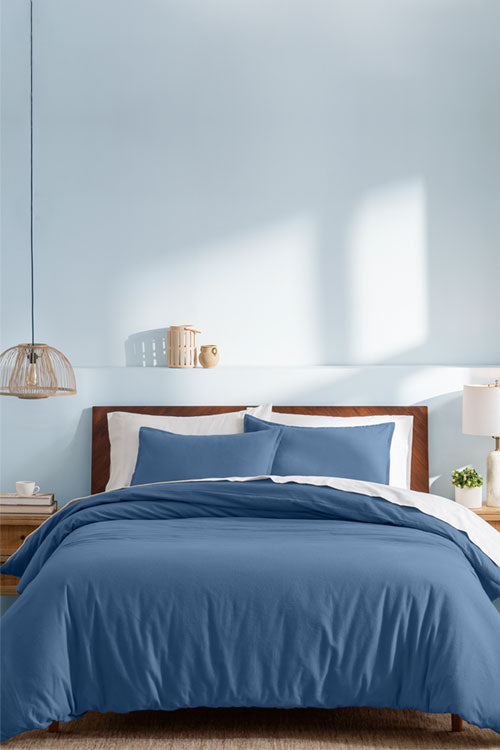 Blue Duvet set in a light blue room with wooden endtables